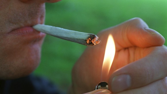 Raucher zuendet einen Joint an, aufgenommen in Zuerich am 28. April 2000. (KEYSTONE/Martin Ruetschi) === ===