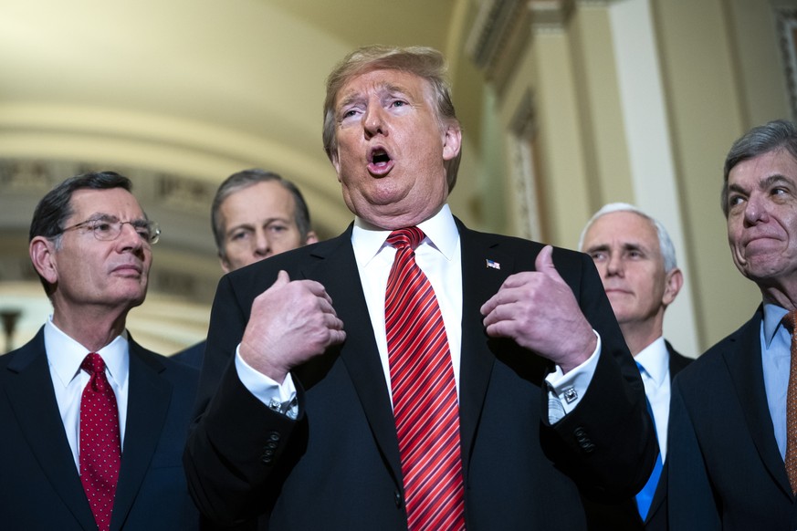 epaselect epa07271920 US President Donald J. Trump (C), along with Vice President Mike Pence (C-R) and Senate Republicans, speaks to the media after attending the Senate Republican policy luncheon in  ...