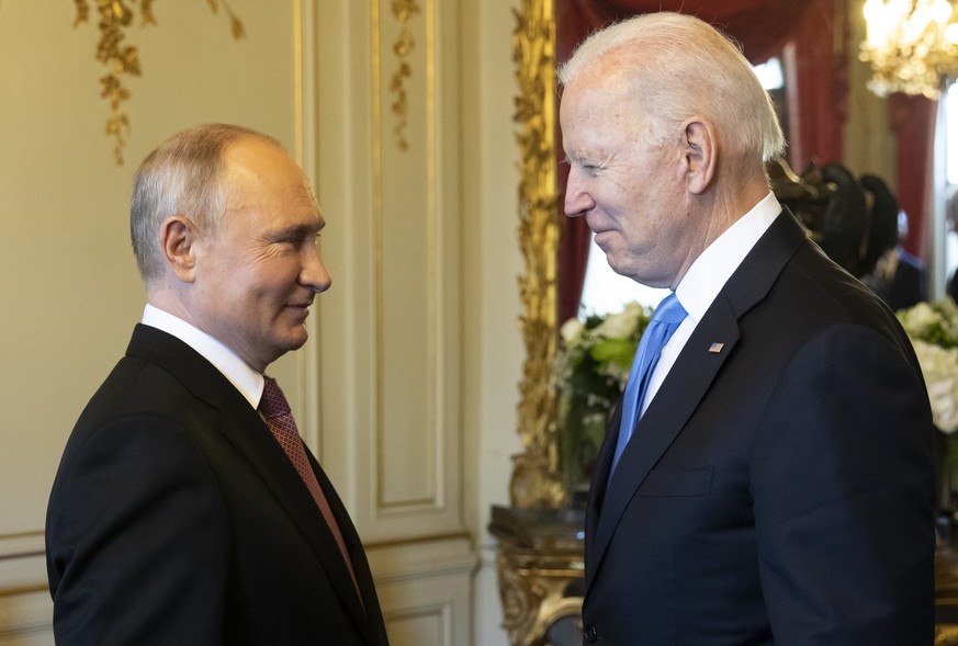 Russian president Vladimir Putin, left, talks to US president Joe Biden after their arrival at the villa La Grange, during the US - Russia summit in Geneva, Switzerland, Wednesday, June 16, 2021. (Swi ...
