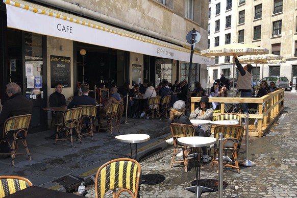 Customers sit at a restaurant terrace in Paris, Wednesday, May, 19, 2021. Cafe and restaurant terraces reopened Wednesday after a six-month coronavirus shutdown deprived residents of the essence of Fr ...