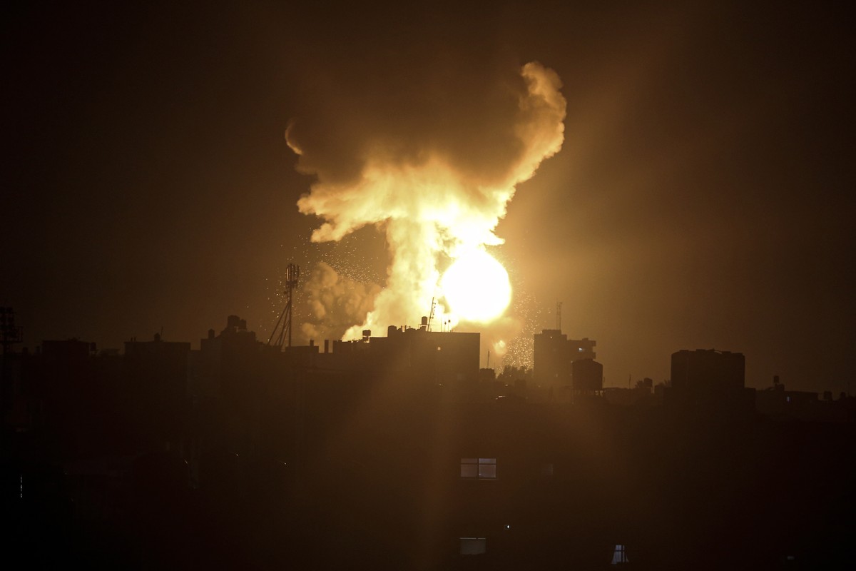 An explosion caused by Israeli airstrikes is seen in the town of Khan Younis, southern Gaza Strip, Sunday Jan, 2, 2022. Israel