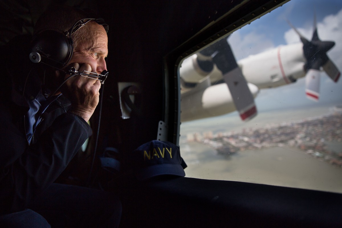 This photo provided by the Governor's Press Office, Gov. Rick Scott looks out the window of a C-130 as he looks at damage to the Florida Keys during the aftermath of Hurricane Irma, Monday, Sept. ...