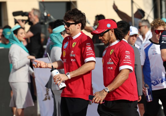 epa12029479 Scuderia Ferrari driver Charles Leclerc of Monaco and his teammate Lewis Hamilton of Britain arrive for the drivers&#039; parade before the Formula One Bahrain Grand Prix in Sakhir, Bahrai ...