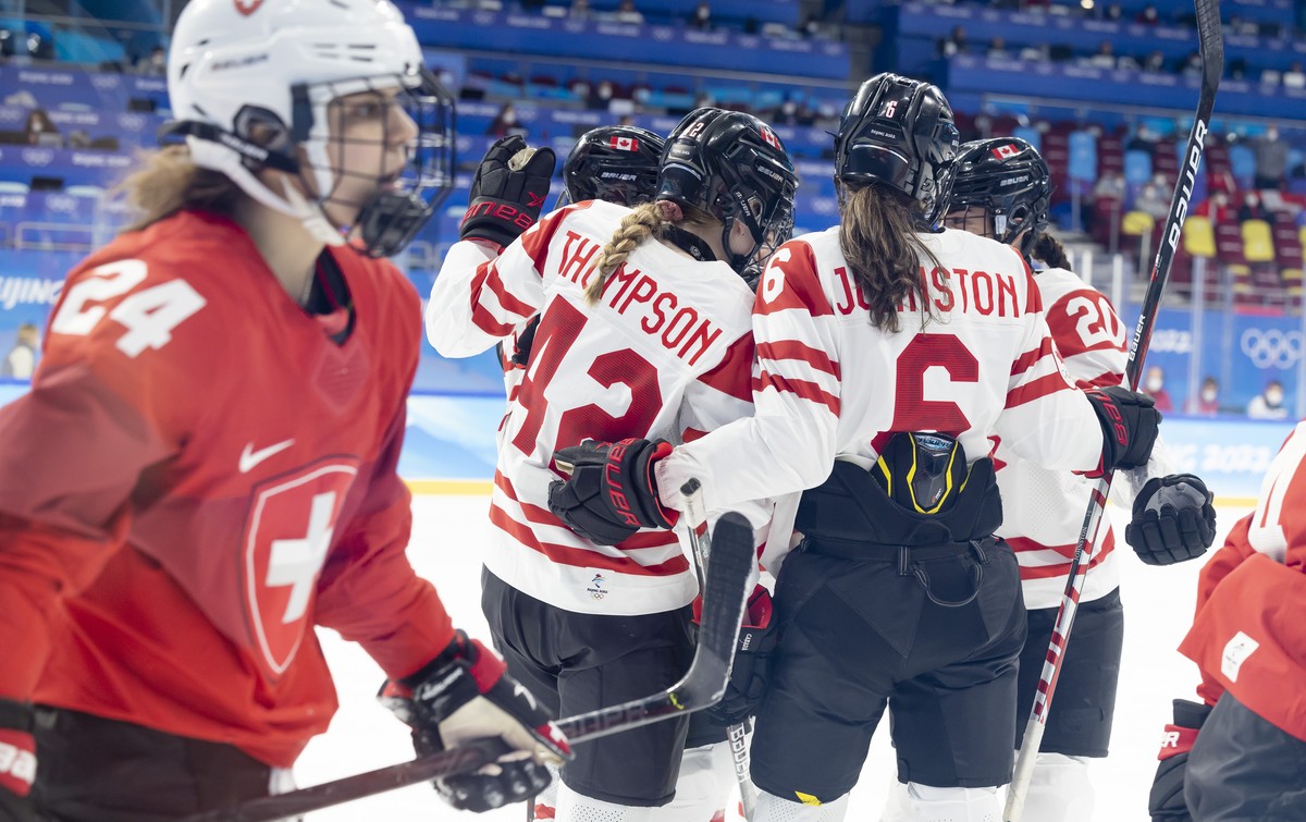 Canada's players celebrate their goal after scoring the 3:0, during the women's ice hockey semifinal game between Canada and Switzerland at the Wukesong Sports Centre at the 2022 Winter Olym ...