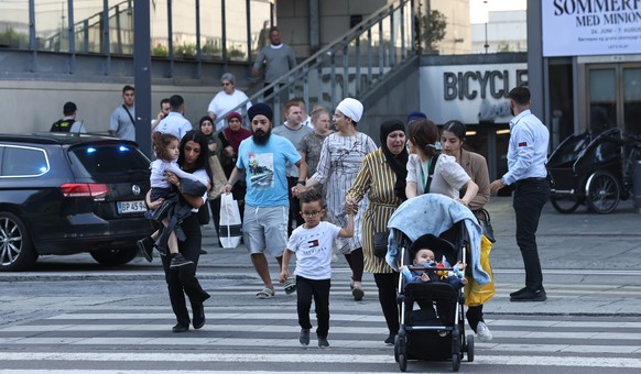 epa10050022 People flee the Fields shopping center during evacuation by armed police, in Oerstad, Copenhagen, Denmark, 03 July 2022. Danish Police has confirmed that shots were fired inside and that s ...