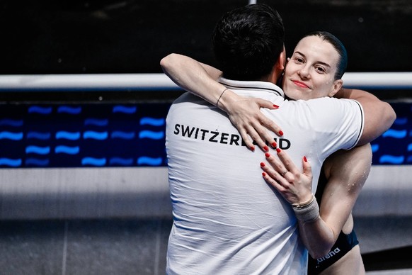 Michelle Luisa Heimberg of Switzerland reacts after competing in the Diving Women s 1m Springboard Final with the coach during the European Aquatics Championships at the Olympic Aquatic Center in Pari ...