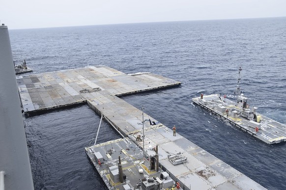 This undated photo released early Tuesday, April 30, 2024, by the U.S. military&#039;s Central Command shows construction off a floating pier in the Mediterranean Sea off the Gaza Strip. A U.S. Navy s ...