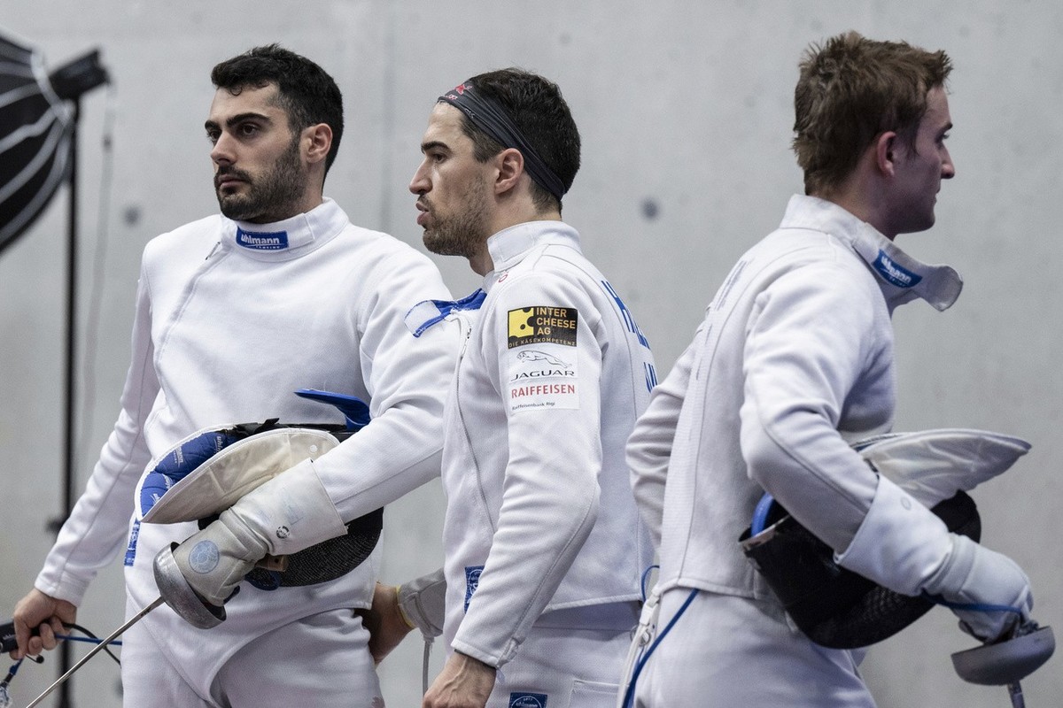 Switzerland?s Alexis Bayard, Max Heinzer and Hadrien Favre, from left, react during the team epee fencing Berne world cup tournament in Guemligen, Switzerland, Sunday, November 13, 2022. (KEYSTONE/Pet ...