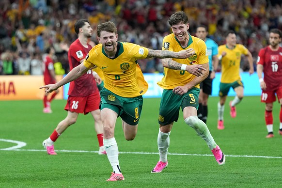 Australia's Connor Metcalfe (8) celebrates with Australia's Jordan Bos (5) after scoring their second goal during the World Cup Group D soccer match between Australia and Turkey in Vancouver ...