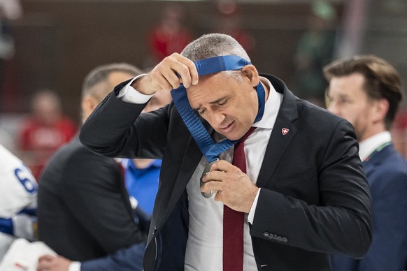 epa13007630 Switzerland's head coach Jan Cadieux looks disappointed as he takes off the silver medal after losing the 2026 IIHF Men's Ice Hockey World Championship gold medal game between Sw ...