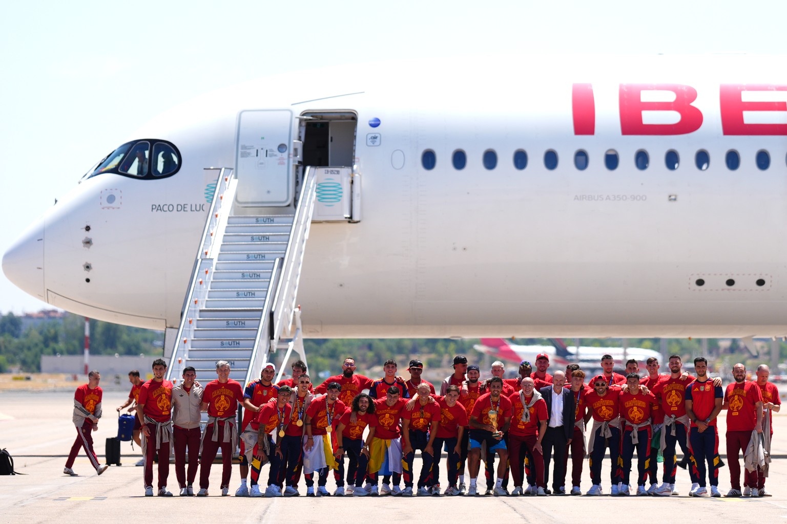 Players from Spain's national soccer team pose with the World Cup trophy as they arrive at Madrid airport on Monday, July 20, 2026, after being crowned World Cup champions with a victory over Arg ...