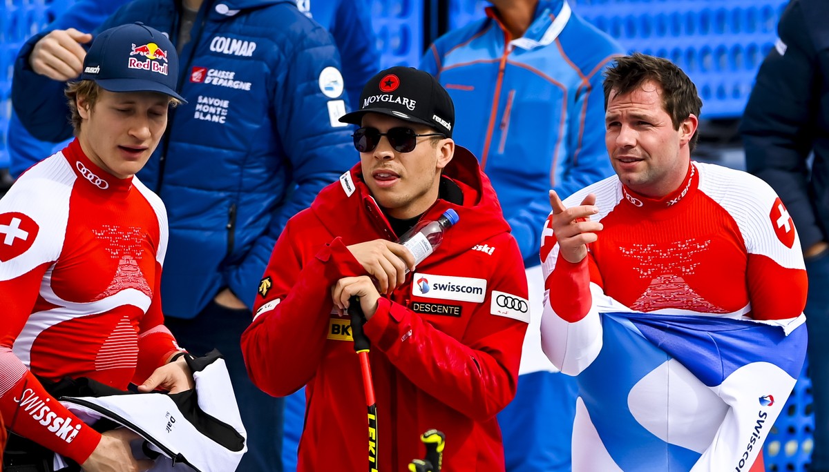 epa09830748 Marco Odermatt (L) Gino Caviezel (C) and Beat Feuz of Switzerland react during the men's Super-G race at the FIS Alpine Skiing World Cup finals in Courchevel, France, 17 March 2022. E ...