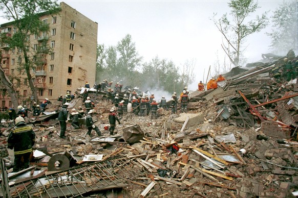 Rescuers and firefighters work at the site of a massive explosion, which destroyed an eight-story apartment building in Moscow, early Monday, Sept. 13, 1999. A Moscow court on Monday, Jan. 12, 2004 se ...