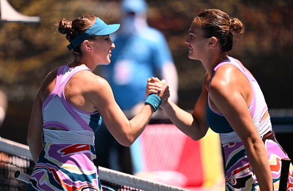epa10424079 Belinda Bencic of Switzerland (L) reacts with Aryna Sabalenka of Belarus following their fourth round match during the 2023 Australian Open tennis championship at Melbourne Park in Melbour ...