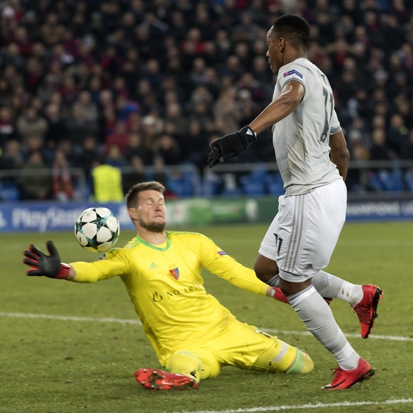 Basel&#039;s goalkeeper Tomas Vaclik, left, blocks a ball against Manchester United&#039;s Anthony Martial, right, during the UEFA Champions League Group stage Group A matchday 5 soccer match between  ...
