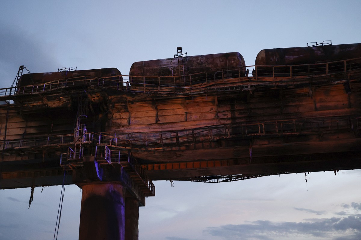 A view of burnt tanks on a damaged part of the Crimean Bridge connecting Russian mainland and Crimean peninsula over the Kerch Strait, near Kerch, Crimea, Saturday, Oct. 8, 2022. Russian authorities s ...