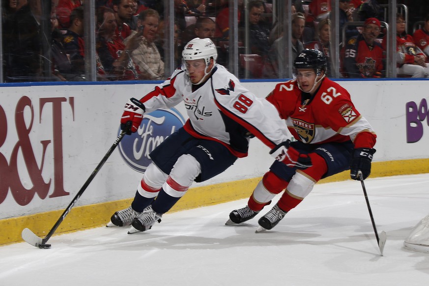 Florida Panthers center Denis Malgin (62) pursues Washington Capitals defenseman Nate Schmidt (88) as he circles the net during the second period of an NHL hockey game, Thursday, Oct. 20, 2016, in Sun ...