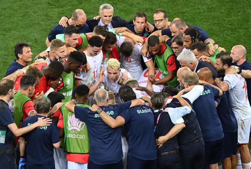 epa09309657 Granit Xhaka of Switzerland (C) talks to his teammates before the penalty shootout during the UEFA EURO 2020 round of 16 soccer match between France and Switzerland in Bucharest, Romania,  ...