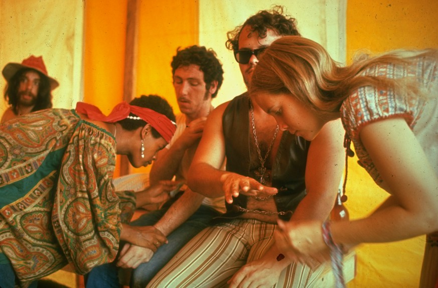 NEW YORK, UNITED STATES - AUGUST 1969: Two unidentified women giving medical care to unidentified men, during the Woodstock Music & Art Fair. (Photo by John Dominis/The LIFE Picture Collection via ...