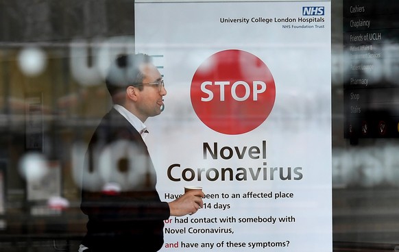 epa08309785 A National Health Service (NHS) worker at a hospital in London, Britain, 20 March 2020. According to news reports, the NHS is planning to increase testing for people suffering from symptom ...