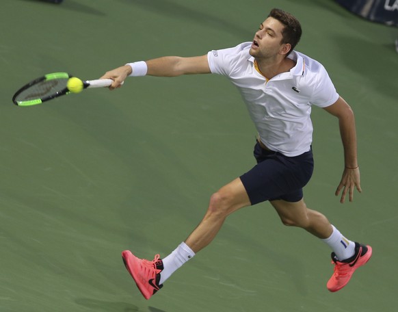 Filip Krajinovic of Serbia returns the ball to Lucas rouille of France during a semi final match of the Dubai Duty Free Tennis Championship in Dubai, United Arab Emirates, Friday, March 2, 2018. (AP P ...