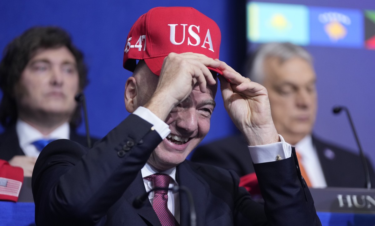 Giovanni Vincenzo Infantino, president of FIFA, tries out a USA hat during a Board of Peace meeting at the U.S. Institute of Peace, Thursday, Feb. 19, 2026, in Washington. (AP Photo/Mark Schiefelbein) ...