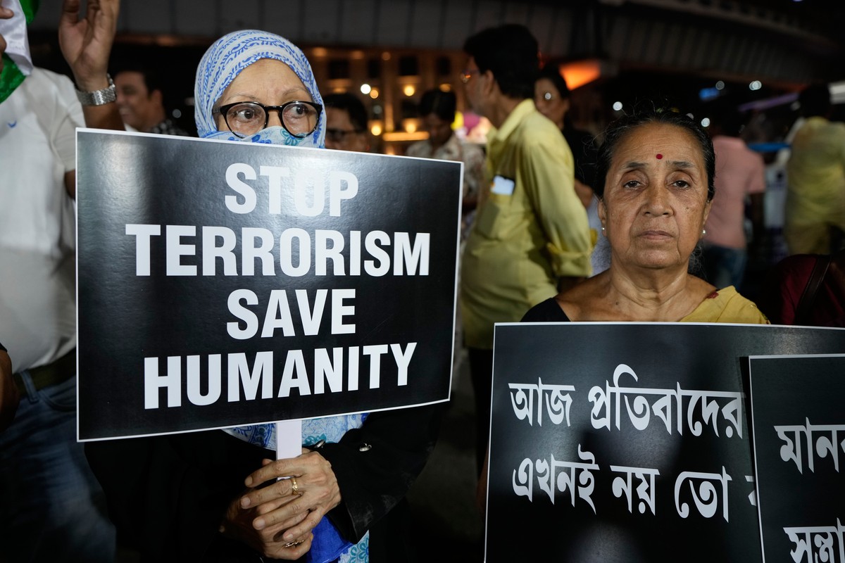 People walk with candles and banners during a protest and solidarity march against the killing of tourists by militants near Pahalgam in Indian controlled Kashmir, in Kolkata, India, Friday, April 25, ...