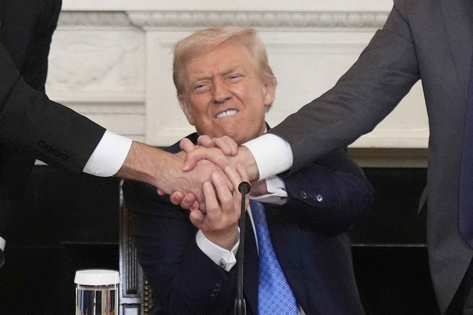 President Donald Trump, center, shakes hands with Armenian Prime Minister Nikol Pashinyan, right, and Azerbaijan President Ilham Aliyev during a trilateral signing ceremony in the State Dining Room of ...