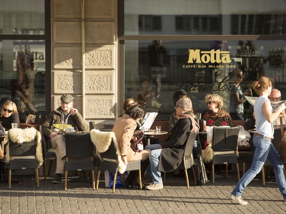 Gaeste geniessen die Sonne vor dem Cafe Bar Motta am Limmatquai am Mittwoch, 23. Dezember 2015, in Zuerich. Ein Hochdruckgebiet mit Zentrum ueber Italien bestimmt derzeit das Wetter, weshalb die Tempe ...