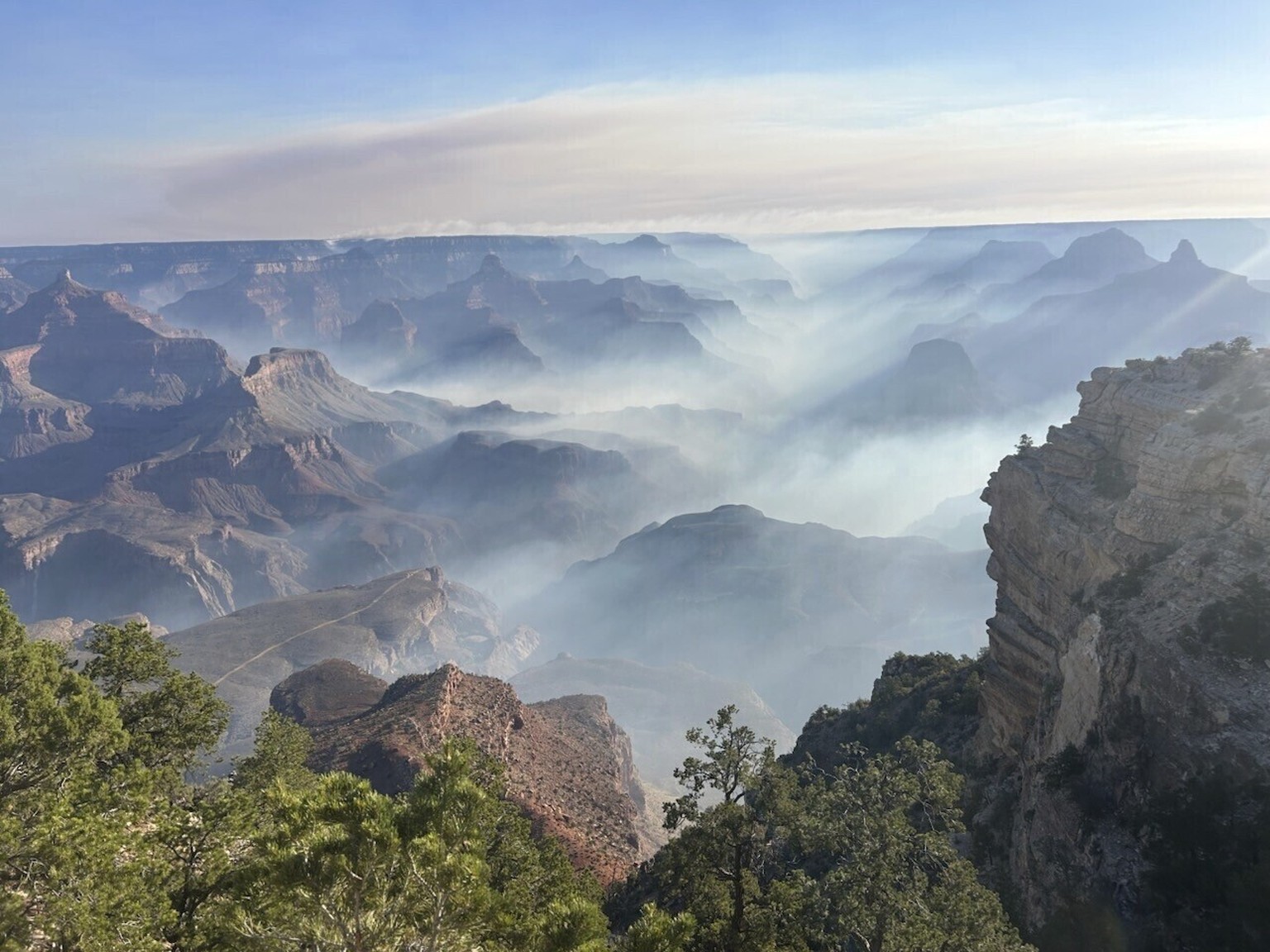 In this photo provided by the National Park Service, smoke from wildfires settles over Grand Canyon National Park in northern Arizona on Friday, July 11, 2025. (Joelle Baird/Grand Canyon National Park ...
