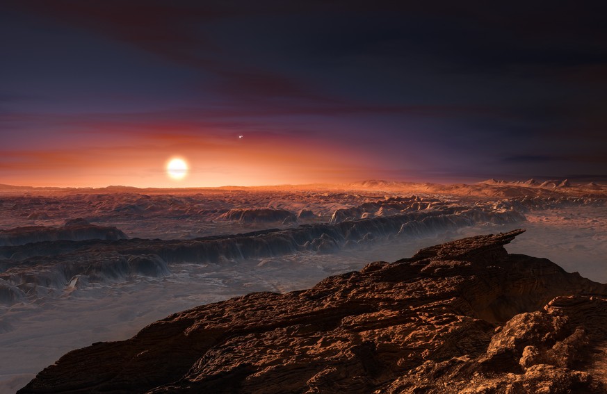 This artist rendering provided by the European Southern Observatory shows a view of the surface of the planet Proxima b orbiting the red dwarf star Proxima Centauri, the closest star to the Solar Syst ...