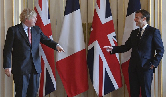 FILE - In this Thursday, June 18, 2020 file photo, French President Emmanuel Macron, right, and Britain&#039;s Prime Minister Boris Johnson, during a visit to 10 Downing Street in London. Britain and  ...