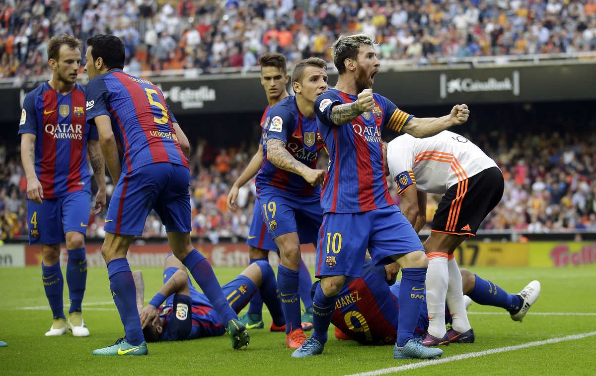 FC Barcelona's Lionel Messi celebrates after scoring a penalty during the Spanish La Liga soccer match between Valencia and FC Barcelona at the Mestalla stadium in Valencia, Spain, Saturday, Oct. ...