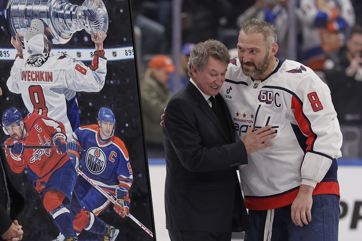 Washington Capitals left wing Alex Ovechkin, right, is greeted by Wayne Gretzky during a ceremony after he scored his 895th career goal during the second period of an NHL hockey game against New York  ...