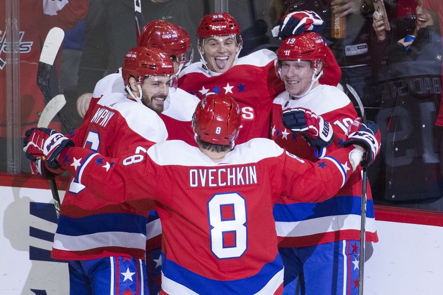 Washington Capitals left wing Andre Burakovsky, center, from Austria, is surrounded by his as he celebrates his goal as left wing Alex Ovechkin, from Russia, joins in during the third period of an NHL ...