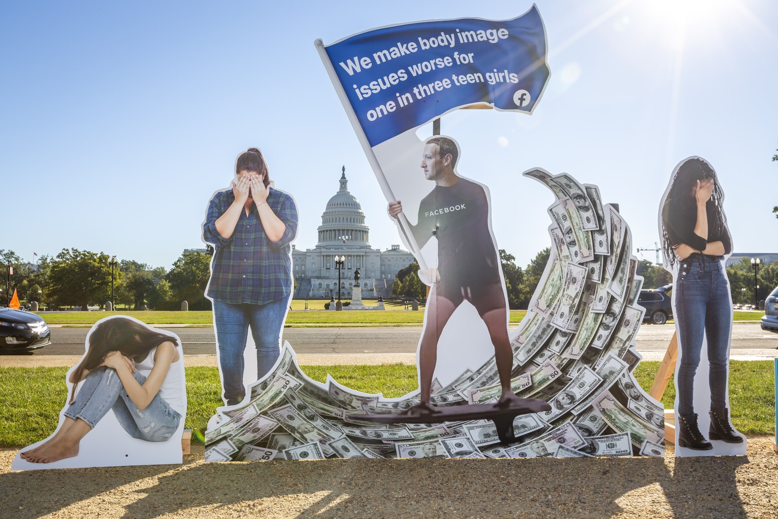 IMAGE DISTRIBUTED FOR SUMOFUS - SumOfUs erected a seven-foot visual protest outside the US Capitol depicting Facebook CEO Mark Zuckerberg surfing on a wave of cash, while young women surround him appe ...
