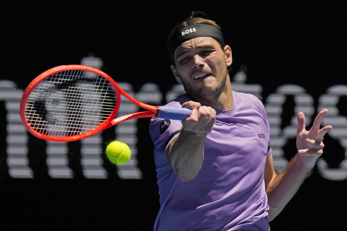 Taylor Fritz of the U.S. plays a forehand return to Jenson Brooksby of the U.S. during their first round match at the Australian Open tennis championship in Melbourne, Australia, Tuesday, Jan. 14, 202 ...