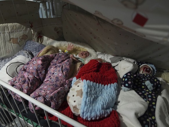 Premature babies who were left behind by their parents lay in a bed in hospital number 3 in Mariupol, Ukraine, Tuesday, March 15, 2022. (AP Photo/Evgeniy Maloletka)