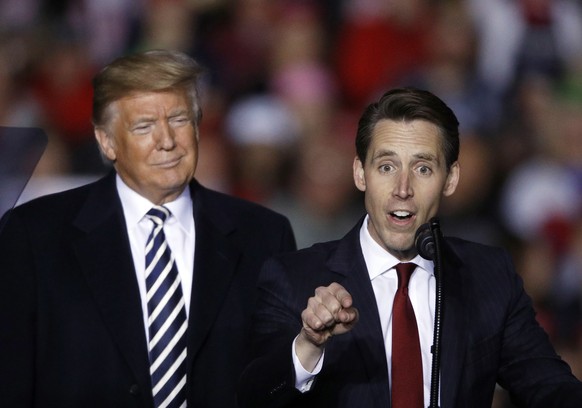 FILE - President Donald Trump listens as Republican Senate candidate Josh Hawley speaks during a campaign rally at Columbia Regional Airport, Thursday, Nov. 1, 2018, in Columbia, Mo. A federal lawsuit ...