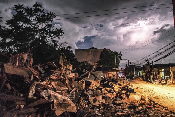 epa12507895 Debris from flood caused by typhoon Kalmaegi are piled up along a road at a residential district in Liloan municipality, Cebu province, Philippines, 06 November 2025. The Philippines&#039; ...