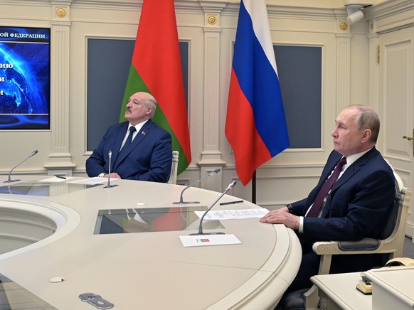 epa09771301 Russian President Vladimir Putin (R) with Belarusian President Alexander Lukashenko (L) begin exercises of the Russian strategic deterrence forces with launches of the ballistic missiles f ...
