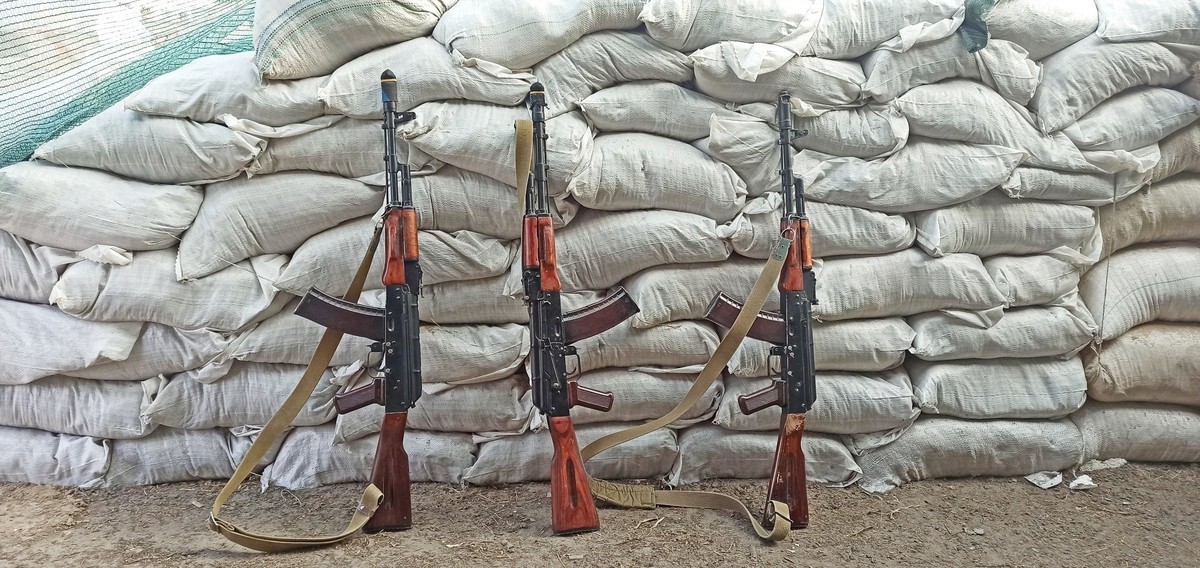 Three Kalashnikovs standing near sandbagged fortifications. kalashnikov assault rifle ak74n standing at barricade. AK-74. Soviet weapon. Assault rifle of struggle. Equipment for war. AK-74 outdoor xkw ...