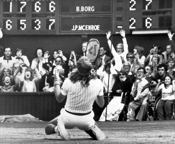 FILE - Sweden&#039;s Bjorn Borg falls to his knees in front of the scoreboard on the Centre Court, Wimbledon, London, July 5, 1980, after beating American John McEnroe, unseen, 1-6, 6-3, 7-5, 6-7, 8-6 ...