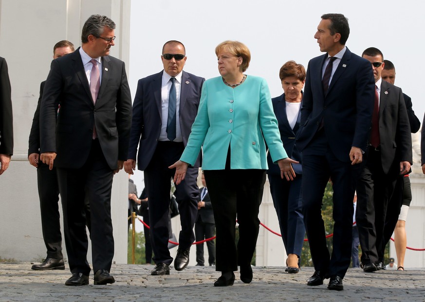 Prime Minister of Croatia Tihomir Oreskovic, German Chancellor Angela Merkel and Austrian Chancellor Christian Kern, front from left, arrive for a group photo at the EU summit in front of Bratislava C ...