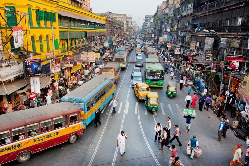 KOLKATA, INDIA - JAN 22: Traffic jam with hundreds of city taxi, buses and pedestrians of busy city road on January 22, 2013 in Calcutta. Kolkata has a density of 814.80 vehicles per km road length