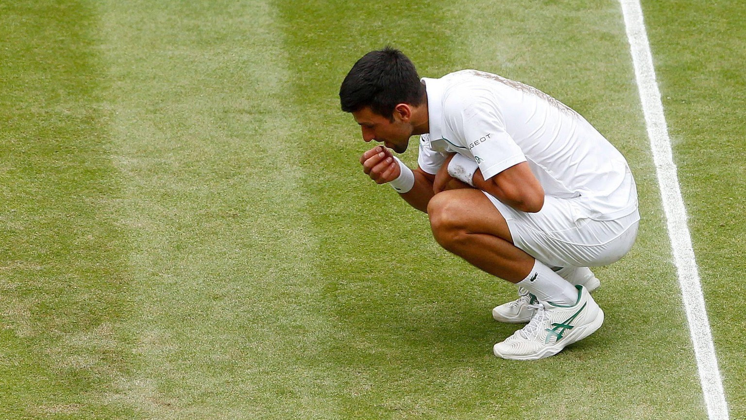 IMAGO / Shutterstock

Mandatory Credit: Photo by Shutterstock (12204580af) Novak Djokovic of Serbia picks a bit of grass to eat Wimbledon Tennis Championships, Day 13, The All England Lawn Tennis and  ...