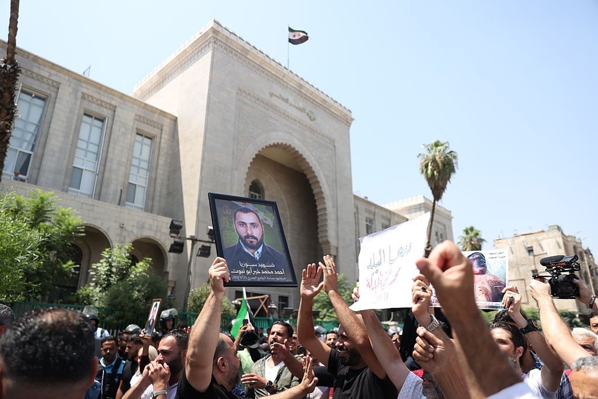 DAMASCUS, SYRIA - AUGUST 11: Syrians gather around the Palace of Justice to celebrate a court's death sentences against ousted leader Bashar al-Assad, his brother Maher al-Assad and his cousin At ...