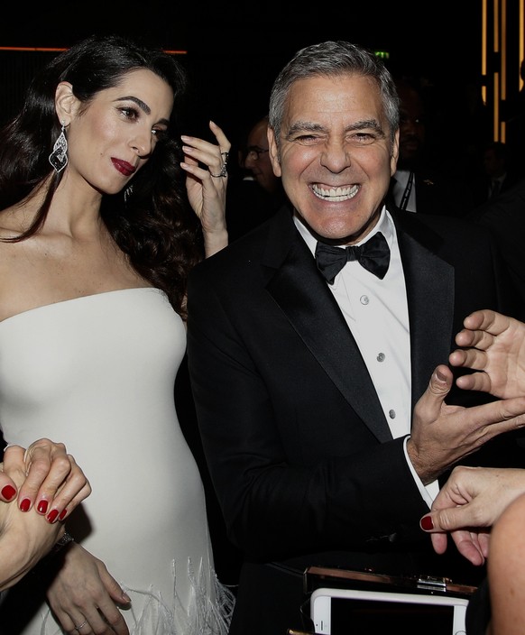 Actor George Clooney and Amal Clooney arrive at the 42nd Cesar Film Awards ceremony at Salle Pleyel in Paris, Friday, Feb. 24, 2017. This annual ceremony is presented by the French Academy of Cinema A ...