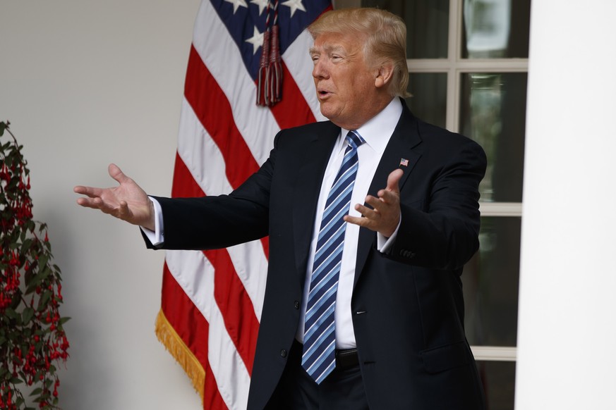 President Donald Trump talks with reporters as he walks to the Oval Office of the White House in Washington, Tuesday, May 2, 2017. President Donald Trump says the nation &quot;needs a good `shutdown&# ...