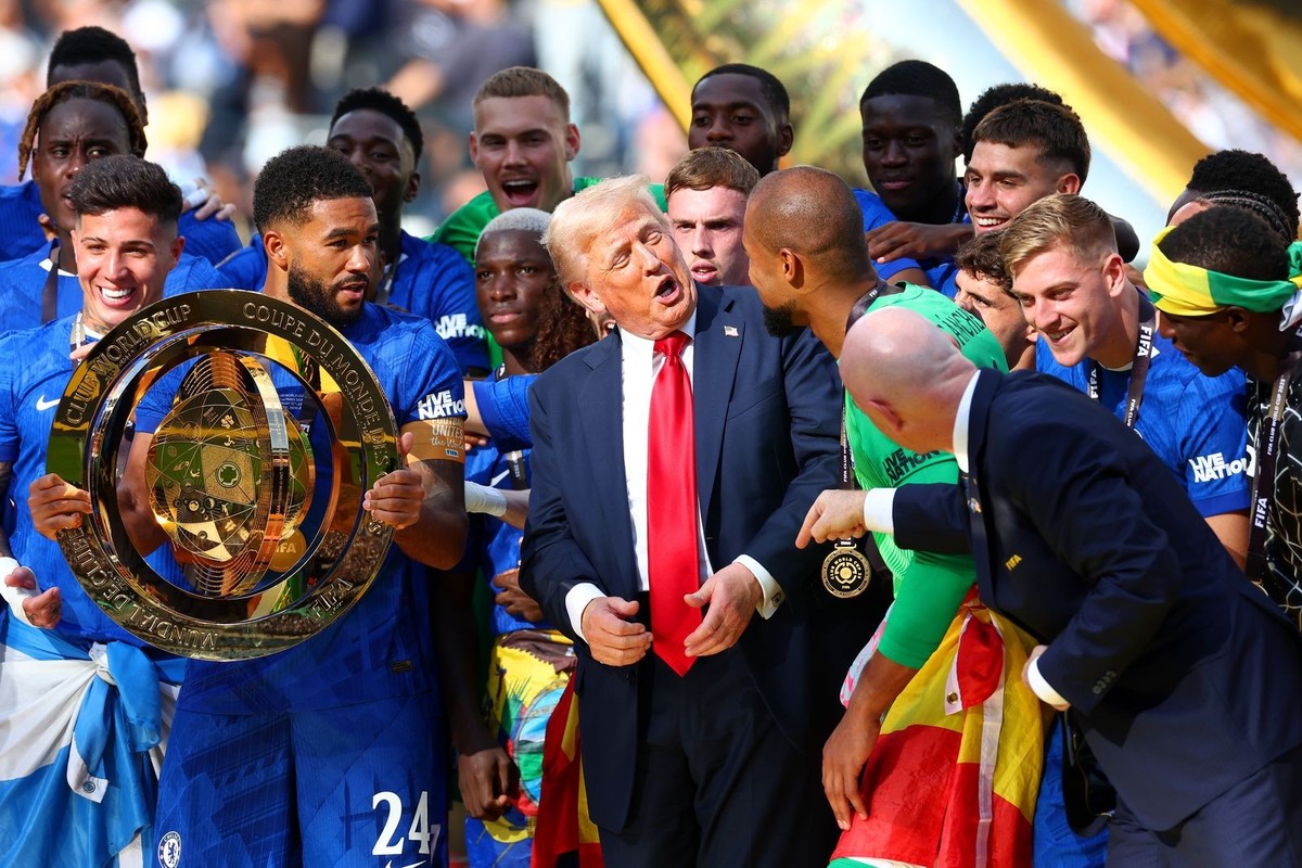 EAST RUTHERFORD, NEW JERSEY - JULY 13: U.S President Donald Trump reacts to Robert Sanchez of Chelsea as Reece James prepares to lift the trophy following the FIFA Club World Cup 2025 final match betw ...